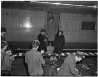 Betsey Cushing Roosevelt being photographed with attorney Basil O'Connor and brother Henry K. Cushing, Los Angeles, February 29, 1940