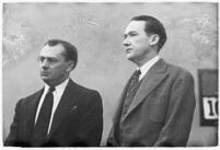 Murder suspect Robert S. James standing between two unidentified men in court, Los Angeles, 1936