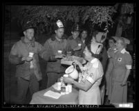 Nurses serving firemen donuts after fire at Hollywood Park racetrack, Calif., 1949