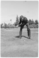 LA Daily News city editor Charles Judson demonstrates improper golf swings for a tutorial series with golfer Fay Coleman. Circa 1940