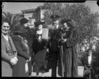 Chief Davis holds the burning mortgage to the Bide-a-Wee home founded by Minnie Barton, Los Angeles, 1935