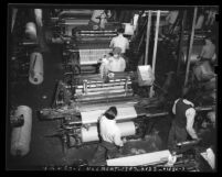 Inmates operating mechanical looms at San Quentin Prison's industrial program, Calif., circa 1948