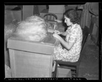 Woman packaging tinsel at National Tinsel Manufacturing Company's Los Angeles warehouse in 1939