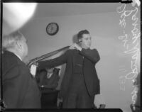 Detective Lieutenant Leroy E. Sanderson reenacts a crime with a gun tagged as evidence, Los Angeles, 1935