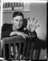 Thomas Edward Dugger, also known as "Ape Man", poses while on trial for assaulting three women, Los Angeles, 1935-1936