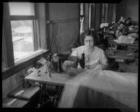 Woman employed by SERA uses sewing machine, Los Angeles, circa 1934