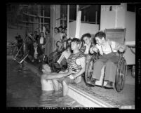 Comedian Buster Crabbe entertaining crippled children during Buster Crabbe's Aqua Parade at Children's Hospital in Los Angeles, Calif., 1948