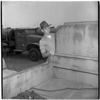 Eldon Farthing examines a truck during the War Assets Administration's surplus sale, Port Hueneme, May 1946