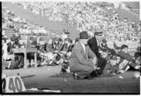 Loyola Lions football coaches watching from the sidelines during a game against the St. Mary's Gaels at the Coliseum, Los Angeles, 1937