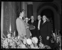 Fire Chief Ralph J. Scott receives a hand-illuminated book at a surprise party in his honor, Los Angeles, 1935