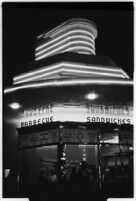 Waitress serves a customer at a drive-in restaurant, Los Angeles