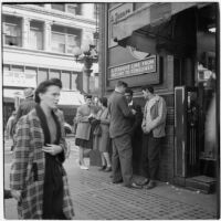 Woman and man talking to truant teenagers downtown, Los Angeles, March 1946