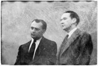 Murder suspect Robert S. James standing next to an unidentified man in court, Los Angeles, 1936