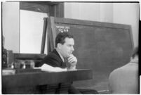 Actor Ben Lyon on the witness stand during a trial for Albert F. Holland, who wrote 150 love letters to Lyon's wife, actress Bebe Daniels, Los Angeles, 1933