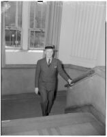 Judge Stanley Moffatt posing at the bottom of a staircase, Huntington Park, 1930-1950