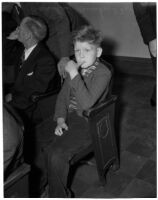 Bradley Bunker, brother of murder victim 11-year-old Marilyn Bunker, sits in court waiting to provide witness testimony, Los Angeles, 1940