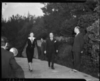 Film star Myrna Loy with film producer husband Arthur Hornblower Jr. walking to Jean Harlow's funeral service, Los Angeles, 1937