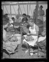 Women peeling potatoes in tent at camp for Jehovah's Witnesses gathering in Los Angeles, Calif., 1947