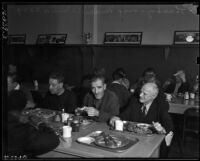 Men enjoy Thanksgiving dinner at the Midnight Mission, Los Angeles, November 25, 1937