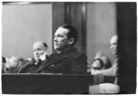 Widower Robert S. James sitting in a courtroom during an inquest involving his wife's death, Los Angeles, 1935