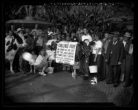 Crowd surrounding 4-H club members milking cow in Pershing Square during California Milk Ship campaign, Los Angeles, Calif., 1948