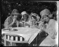 Members of the Wilshire Women's club don sun bonnets for a charity event, Los Angeles, 1935