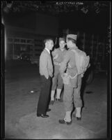 U.S. Army soliders talk to a civilian on Terminal Island (Calif.)