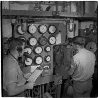 Man operates a machine during Army-Navy maneuvers off the coast of Southern California in late 1946