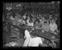 Students waiting at counter on first day of classes in 1946 at Los Angeles City College