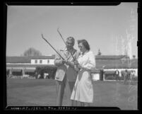 Olin Dutra and Babe Didrikson Zaharias golfing, circa 1945