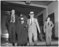 Evangelist and political figure Robert P. Shuler walking with his wife, Nelle, Los Angeles