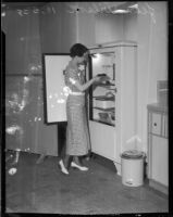 Jean Wilson stores food in refrigerator, Los Angeles, 1930s