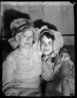 Mrs. John Witty and Margaret Herroder don bonnets for charity, Los Angeles, 1935