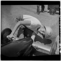 Al Pedrosa looks up from checking on his soap box derby car, Los Angeles, 1946