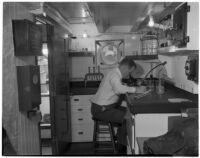 D.H. Fry Jr. in the laboratory of the California Dept. of Fish and Game's research ship, the N.B. Scofield, Los Angeles, May 23, 1940