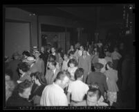 Nighttime shoppers walking past window displays near Hill and 7th Streets in Los Angeles, Calif., 1948