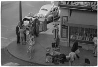 Aerial view of pedestrians and Owl Drug on the corner of Hollywood and Vine, Los Angeles, 1940