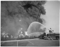 Fire fighters hose down one of many fires that raged after the Markay oil tanker exploded in L.A. Harbor, Los Angeles, 1947