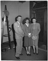 Shirley Smith stands with her mother, Betty Alice Phillips, and father, Melvin David Smith, outside of the courtroom while Superior Judge Fred Miller decides on a home for her after her divorced parents declare they do not want custody, Los Angeles, 1947