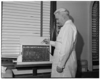 Dr. Raymond L. Carey with honeybees used to treat his patients' arthritis, Los Angeles, November 9, 1941