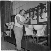 Employee making toilet bowls at the Universal Vitreous China Factory, Mentone, circa 1948