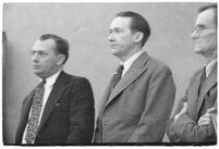 Murder suspect Robert S. James standing between two unidentified men in court, Los Angeles, 1936