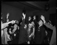 Self-proclaimed benefactor of the elderly Robert Noble, surrounded by some of his followers in the courtroom where he is charged with several misdemeanors, Los Angeles, 1937-1938