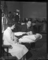 Busby Berkeley on a strecher accompanied by his lawyer Jerry Geisler and nurse Marie Ganchom, Los Angeles, 1935