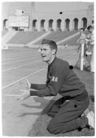 USC track athlete clapping on the sidelines at a meet, Los Angeles, 1937