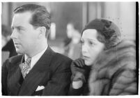 Actor Ben Lyon with his wife, actress Bebe Daniels, during a trial for Albert F. Holland, who wrote 150 love letters to Daniels, Los Angeles, 1933