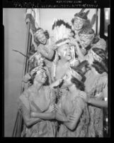 Roger Plaisted surrounded by Indian maidens of Aqua Gala at Los Angeles Swimming Stadium, 1949