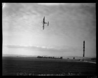 Airplane performing a trick at the National Air Races, Los Angeles, 1936