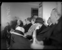 Mrs. Buron Fitts bows her head in a crowded room, Los Angeles, 1934