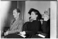 Private detective Pearl Antibus shields her face as she appears in court with her daughter Norma Thelan during her trial against millionaire Thomas W. Warner, Sr, Los Angeles, 1938